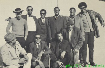 1969 AFBF ensemble (l to r) (standing): Earl Hooker, Cleveland Chenier, Magic Sam, Carey Bell, John Jackson, Robert St. [not 'Judy'] Julien, Willy Leiser (headlocked, almost invisible); (kneeling): Juke Boy Bonner, Clifton Chenier, Mac Thompson, 'Whistling' Alex Moore; source: Back cover of Arhoolie 1048 'Alex Moore in Europe'; photographer: Chris Strachwitz; click to enlarge!