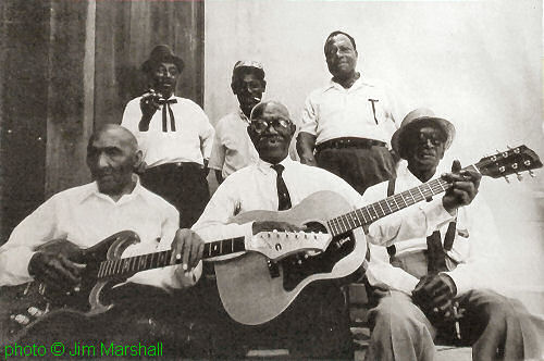 standing: Fred McDowell, Johnny Woods, Booker White; sitting: Nathan Beauregard, Furry Lewis, Sleepy John Estes; source: Front cover of Arhoolie 1084/1085; photographer: Jim Marshall; click to enlarge!
