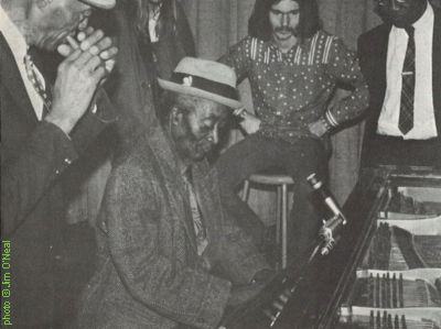 Dewey Corley, Willie '61' Blackwell (at the piano), George Paulus & Furry Lewis at the River City Blues Festival (produced by Steve LaVere), Ellis Auditorium in Memphis, TN, December 3, 1971; source: Living Blues 7 (Winter 1971-72), p. 8; photographer: Jim O'Neal