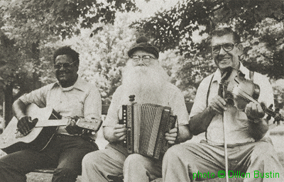 Jim Brewer with Michael Kennedy and Strawberry McCloud at the New Harmony Festival of Traditional Music, June 1977; source: Sing Out! 31/2 (1985), p. 30; photo by Dillon Bustin; click to enlarge!