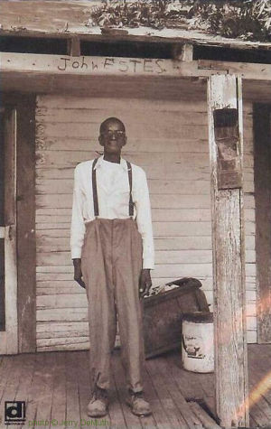 ' S L E E P Y'   J O H N   E S T E S on the front porch of his home in Brownsville, TN, c. 1966; source: Photo (on p. 10) accompanying Jerry DeMuth's article 'Sleepy John Estes - Legend In A Shack' in Down Beat 39, # 19 (November 11, 1971), pp. 10, 29; photographer: Jerry DeMuth; click to enlarge!