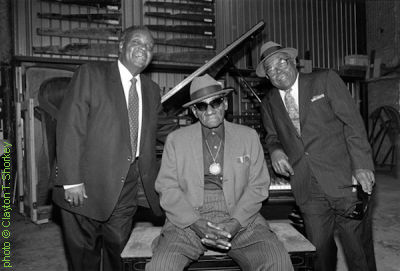 The 'Texas Piano Professors' (l to r) Lavada Durst (Dr. Hepcat), Roosevelt T. Williams (the G R E Y   G H O S T), and Erbie Bowser at Mollberg & Assoc. Piano Restoration, Austin, TX, ca. early 1990s; source: https://tshaonline.org/handbook/online/articles/fwibe; photographer: Clayton T. Shorkey, Texas Music Museum