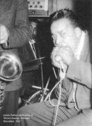 Muddy Waters Band at Silvio's Lounge, Chicago, December 1957; Pat Hare, g; Otis Spann, p; Muddy Waters, voc; not Big Crawford [died in March 1956!] Samuel 'Singin' Sam' Chatmon, b; unknown saxophonist [prob. Sax Mallard]; Elga Edmonds, dr [in adjacent photo!]; James Cotton, hca [in main photo only hands holding microphone visible]