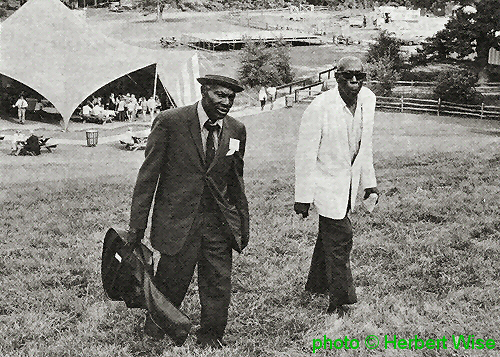 Earl Bell and Mose Vinson on the grounds of the 33rd National Folk Festival 1971<br>source: Sing Out! vol. 20 # 6 (1971), p. 7; photographer: Herbert Wise