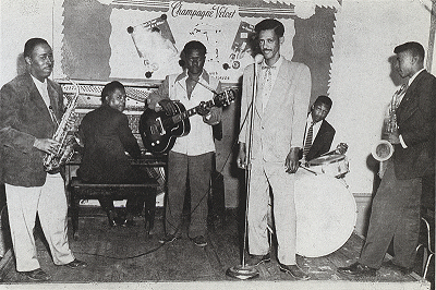 Willie Nix and his band ('Satchel Paige', saxophone; Jerry McConkle, guitar [seated at piano]; Joe Willie Wilkins, guitar; Willie Nix, drums / vocals; unidentified musician seated at drums; Billy Adolph Duncan, saxophone); source: Postcard from postcard book by Stephen C. LaVere (Pomegranate Artbooks 1989, revised 1993); 'photograph courtesy Patty Nix'; click to enlarge!