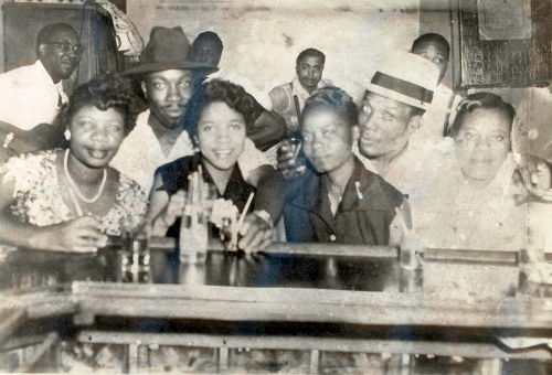 At Silvio's Lounge, Chicago, IL, mid 1950s: Band in the background, l to r: Muddy Waters (wearing glasses), Otis Spann, Elga Edmonds, Jimmy Rogers; At the bar, l to r: Viola Spearman (Koko Taylor's sister), Levi Walton (Koko Taylor's brother), Vera Walton (Levi Walton's wife), Koko Taylor, Robert Taylor, Savannah Becton (Koko Taylor's sister); source: Koko Taylor Collection, courtesy of Alligator Records - Tim Kolleth at https://bobcorritore.com/photos/koko-taylor-photo-page/</a>; a bit photoshop treated by Stefan Wirz