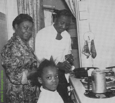 Muddy Waters with his wife Geneva (née Ward, 1915 - March 16, 1973, they married in 1940) and their granddaughter (which they raised) Amelia 'Cookie' Cooper in their home at 4339 South Lake Park in Chicago, Illinpois, November 1959; source: Internet; photographer's name not given